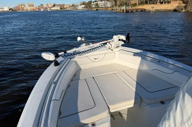 Slide: The Image of 2015 Sea Hunt Gamefish 25 boat on calm water, featuring spacious seating area. - 7