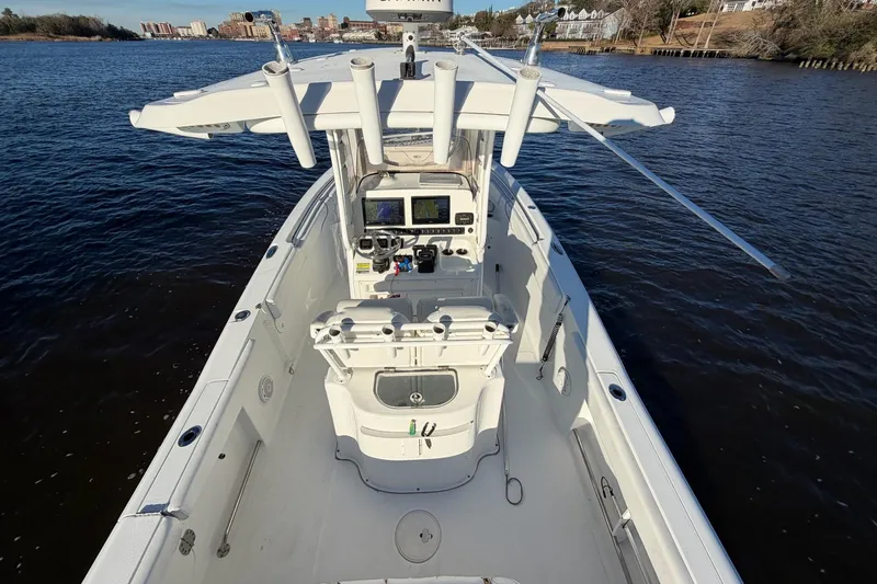 Slide: The Image of 2015 Sea Hunt Gamefish 25 boat on water, featuring a spacious deck and modern controls. - 9