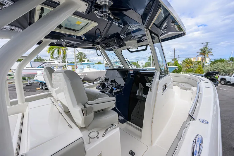 Slide: The Image of 2023 Pursuit S 328 Sport boat interior with helm and seating area. - 13