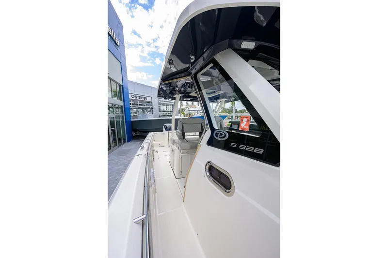 Slide: The Image of 2023 Pursuit S 328 Sport boat exterior view at a dealership. - 14