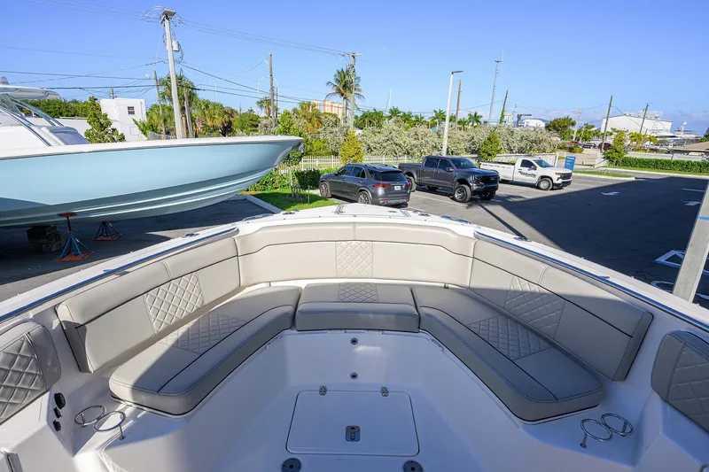 Slide: The Image of 2023 Pursuit S 328 Sport boat with spacious seating in a marina setting. - 17