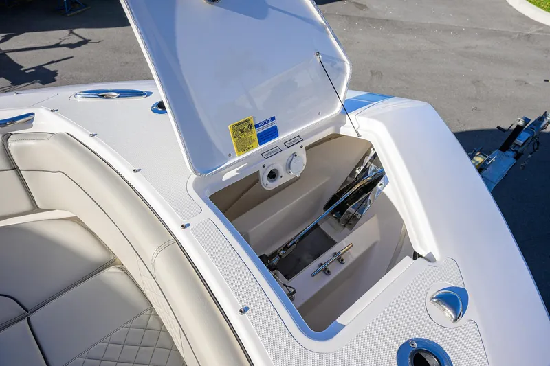 Slide: The Image of 2023 Pursuit S 328 Sport boat anchor storage compartment with open hatch. - 19