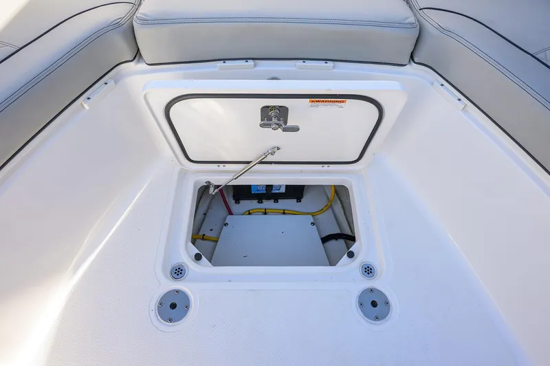 Slide: The Image of 2023 Pursuit S 328 Sport boat storage compartment with open hatch and visible wiring. - 22