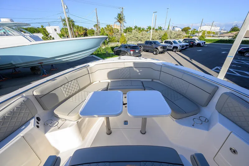 Slide: The Image of 2023 Pursuit S 328 Sport boat with spacious seating and dual tables. - 31