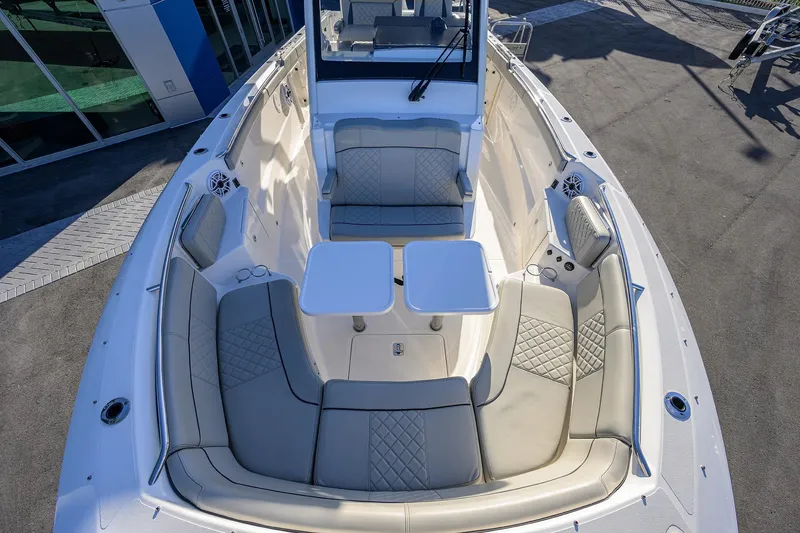 Slide: The Image of 2023 Pursuit S 328 Sport boat interior with cushioned seating and dual tables. - 32