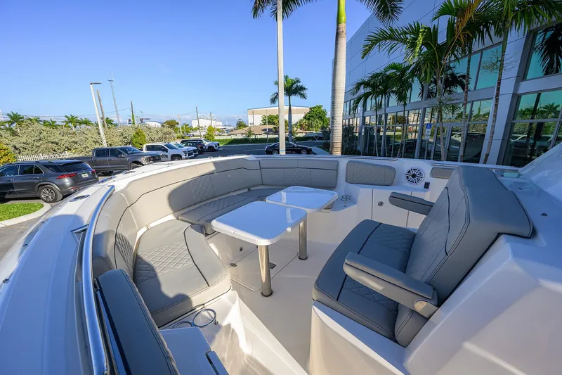 Slide: The Image of 2023 Pursuit S 328 Sport boat interior with luxurious seating and table setup. - 33