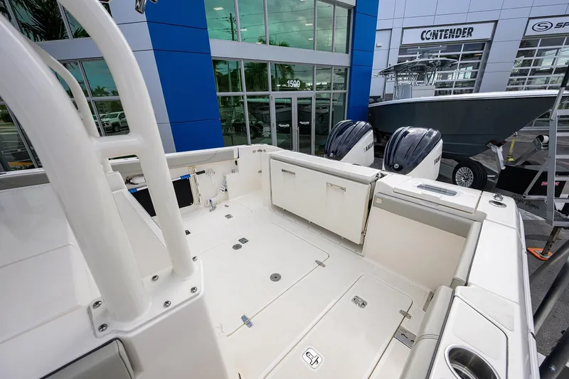 Slide: The Image of 2023 Pursuit S 328 Sport boat interior with dual Yamaha engines at dealership. - 34