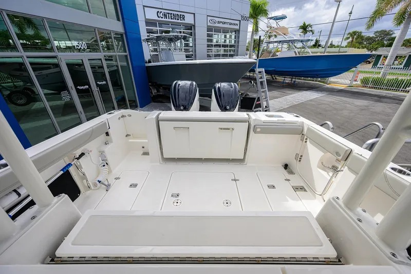Slide: The Image of 2023 Pursuit S 328 Sport boat interior at dealership, showcasing spacious deck and modern design. - 35