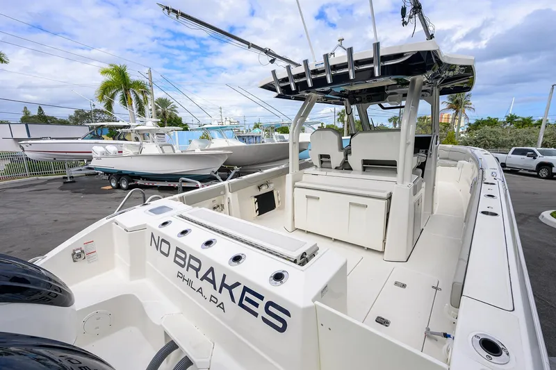 Slide: The Image of 2023 Pursuit S 328 Sport boat with "No Brakes" text, docked in a marina. - 37
