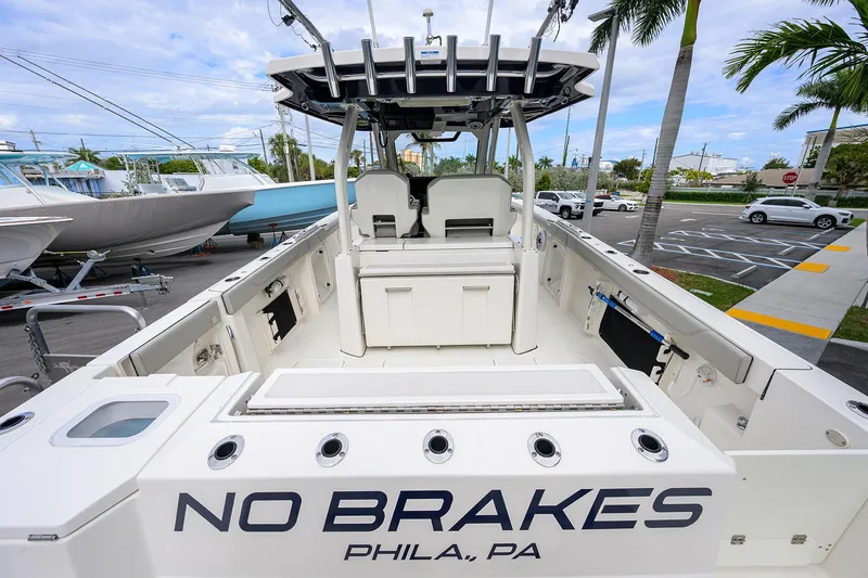 Slide: The Image of 2023 Pursuit S 328 Sport boat, "No Brakes," docked in a sunny marina. - 38