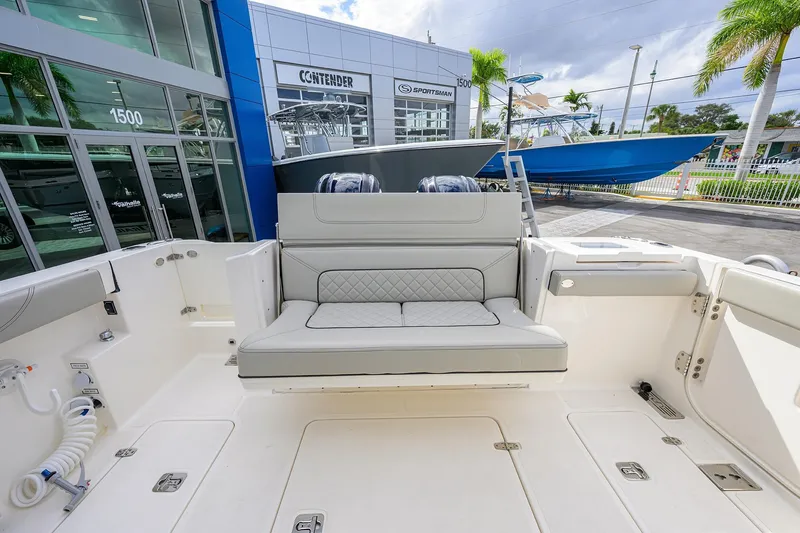 Slide: The Image of 2023 Pursuit S 328 Sport boat interior with seating, displayed at a dealership. - 46