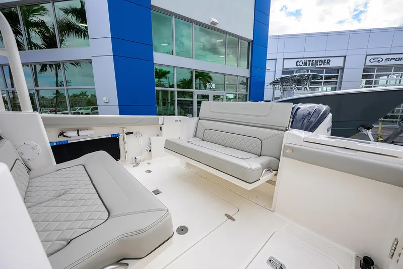 Slide: The Image of 2023 Pursuit S 328 Sport boat interior with luxurious seating at a dealership. - 47