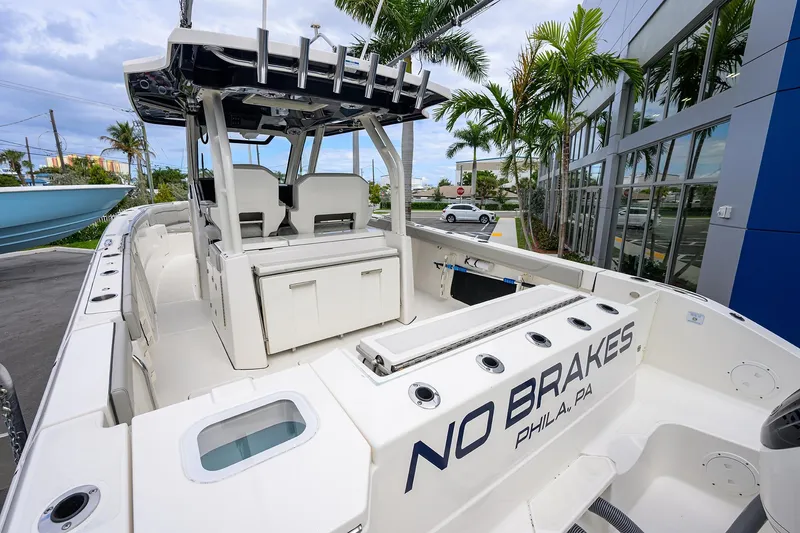 Slide: The Image of 2023 Pursuit S 328 Sport boat with "No Brakes" text, docked near palm trees. - 5