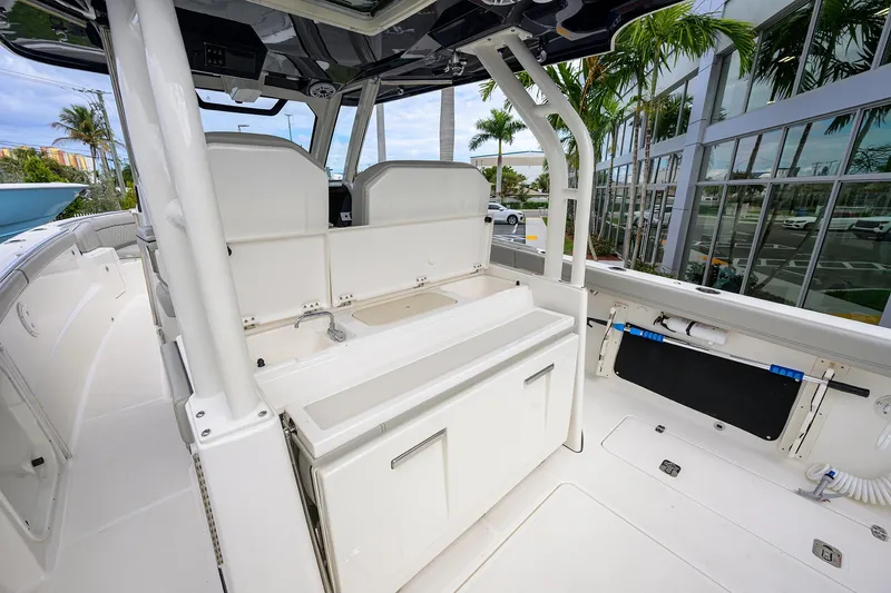 Slide: The Image of 2023 Pursuit S 328 Sport boat interior with seating and storage, featuring modern design elements. - 53
