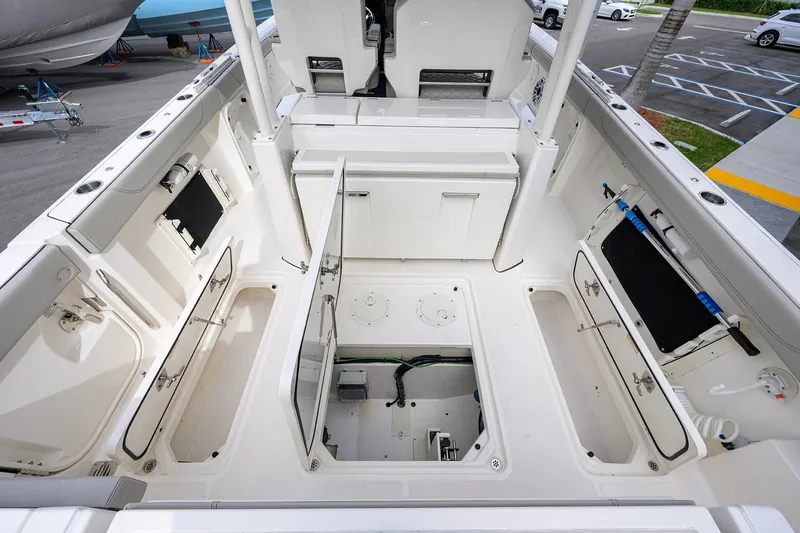 Slide: The Image of 2023 Pursuit S 328 Sport boat interior with open storage compartments and sleek design. - 56