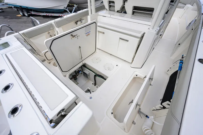 Slide: The Image of 2023 Pursuit S 328 Sport boat interior with open storage compartments and seating. - 57