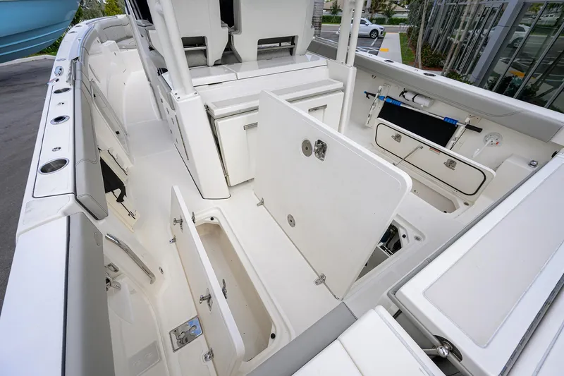 Slide: The Image of 2023 Pursuit S 328 Sport boat interior with open storage compartments. - 58