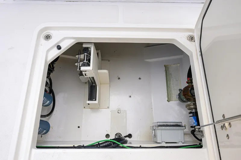 Slide: The Image of 2023 Pursuit S 328 Sport boat compartment with mechanical components and wiring. - 59