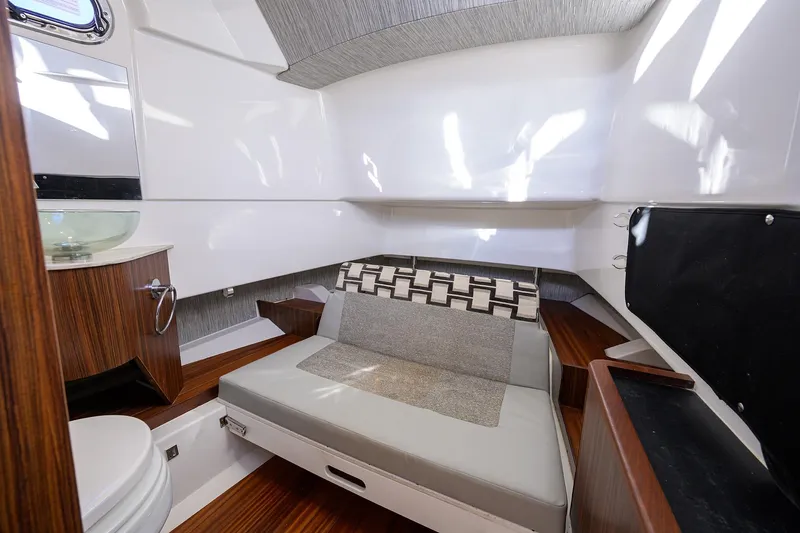 Slide: The Image of Interior cabin of 2023 Pursuit S 328 Sport boat with seating and wood accents. - 63