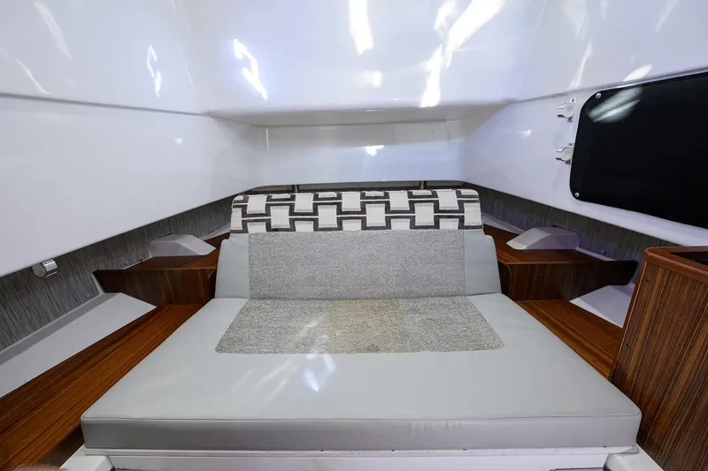 Slide: The Image of 2023 Pursuit S 328 Sport cabin interior with modern seating and wood accents. - 64