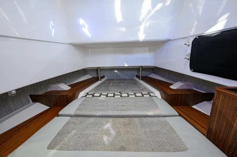 Slide: The Image of 2023 Pursuit S 328 Sport cabin interior with sleek design and comfortable bedding. - 69