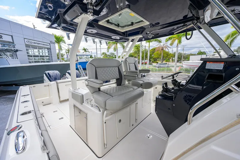 Slide: The Image of 2023 Pursuit S 328 Sport boat interior with luxurious seating and modern controls. - 9