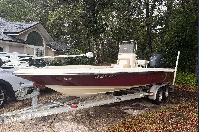 Slide: The Image of 2006 ShearWater Z2200 boat on trailer, parked outdoors near a house. - 1