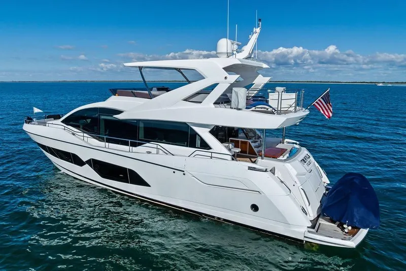 Slide: The Image of 2019 Sunseeker 76 Yacht cruising on open water under clear blue skies. - 4
