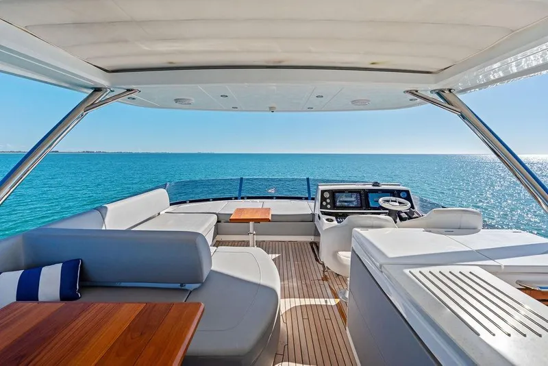 Slide: The Image of Luxurious 2019 Sunseeker 76 Yacht interior with ocean view, featuring elegant seating and navigation area. - 44