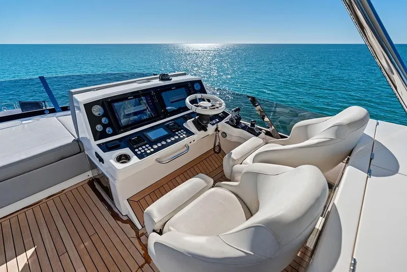 Slide: The Image of Luxurious 2019 Sunseeker 76 Yacht helm with ocean view and modern controls. - 46