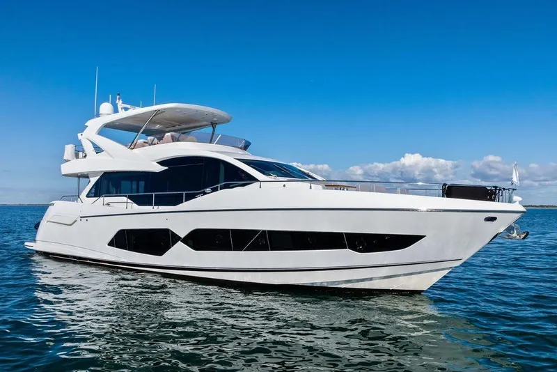 Slide: The Image of Luxurious 2019 Sunseeker 76 Yacht cruising on open water under clear blue skies. - 5
