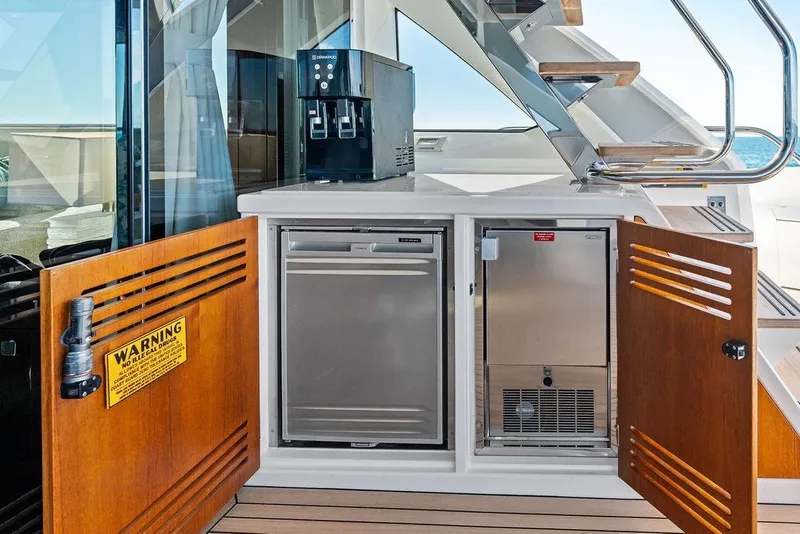 Slide: The Image of Sunseeker 76 Yacht 2019 interior with open cabinets and coffee machine. - 50