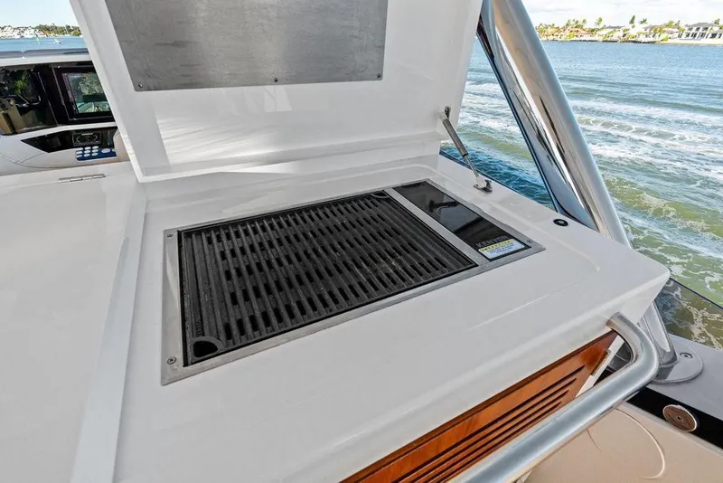 Slide: The Image of Outdoor grill on 2019 Sunseeker 76 Yacht, overlooking serene water view. - 51