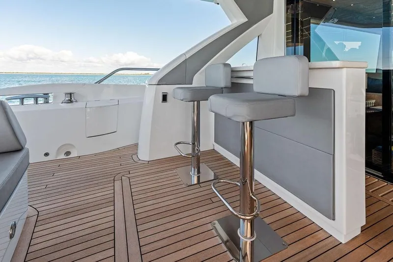 Slide: The Image of Luxury Sunseeker 76 Yacht 2019 deck with modern bar stools and ocean view. - 56