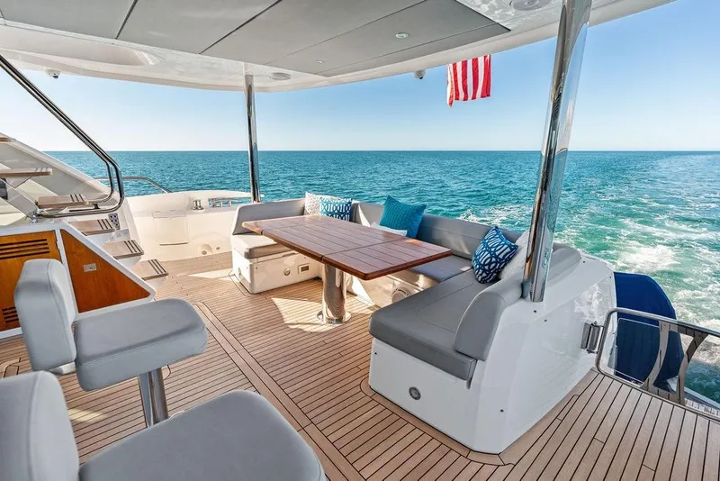 Slide: The Image of Luxurious 2019 Sunseeker 76 Yacht deck with ocean view and elegant seating area. - 58