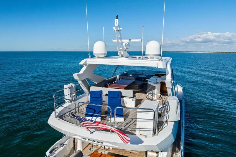 Slide: The Image of 2019 Sunseeker 76 Yacht on open sea, featuring spacious deck and modern design. - 6