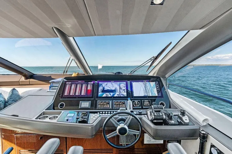 Slide: The Image of Cockpit view of 2019 Sunseeker 76 Yacht with advanced navigation systems. - 63