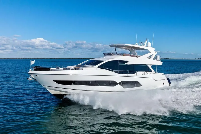 Slide: The Image of 2019 Sunseeker 76 Yacht cruising on open water under a clear blue sky. - 7
