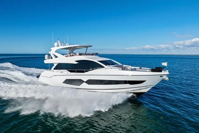 Slide: The Image of Luxurious 2019 Sunseeker 76 Yacht cruising on open sea under clear blue sky. - 8