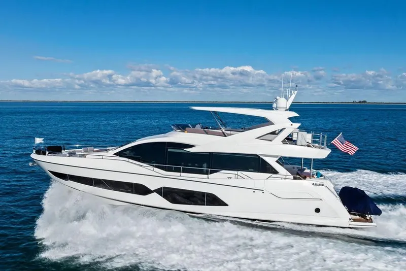 Slide: The Image of 2019 Sunseeker 76 Yacht cruising on open water under a clear blue sky. - 9