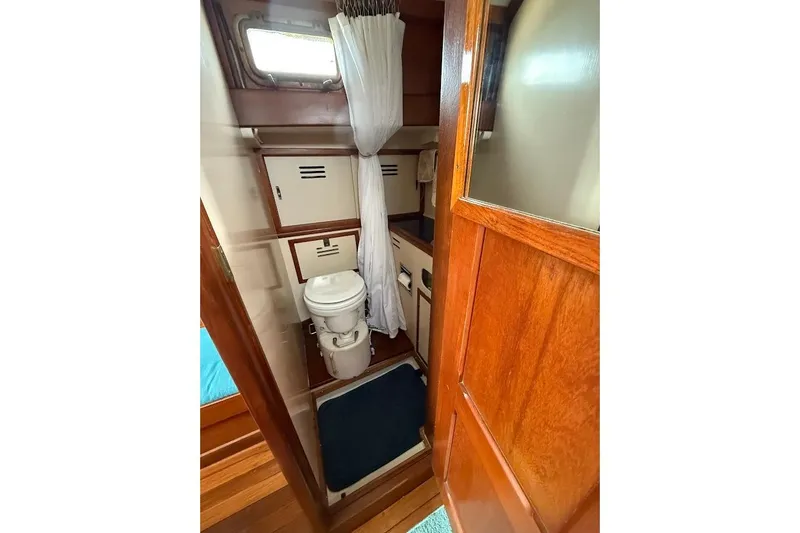 Slide: The Image of 1962 Ted Hood Little Harbor 40 Yawl bathroom with wooden door and compact design. - 10