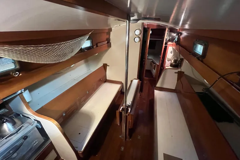Slide: The Image of Interior of 1962 Ted Hood Little Harbor 40 Yawl, featuring wooden benches and nautical decor. - 11