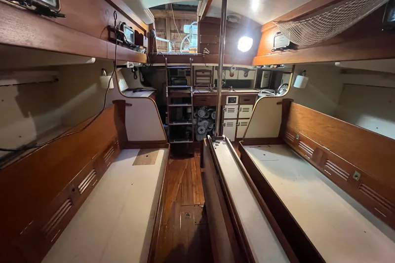 Slide: The Image of Interior of a 1962 Ted Hood Little Harbor 40 Yawl, featuring wooden benches and storage. - 12