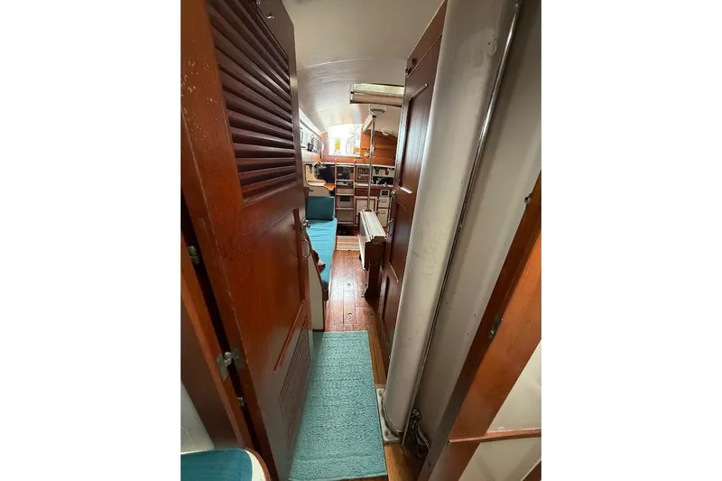 Slide: The Image of Interior view of 1962 Ted Hood Little Harbor 40 Yawl, featuring wooden finishes and cozy seating. - 14