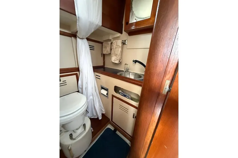 Slide: The Image of Interior of 1962 Ted Hood Little Harbor 40 Yawl, featuring compact bathroom with sink and toilet. - 15