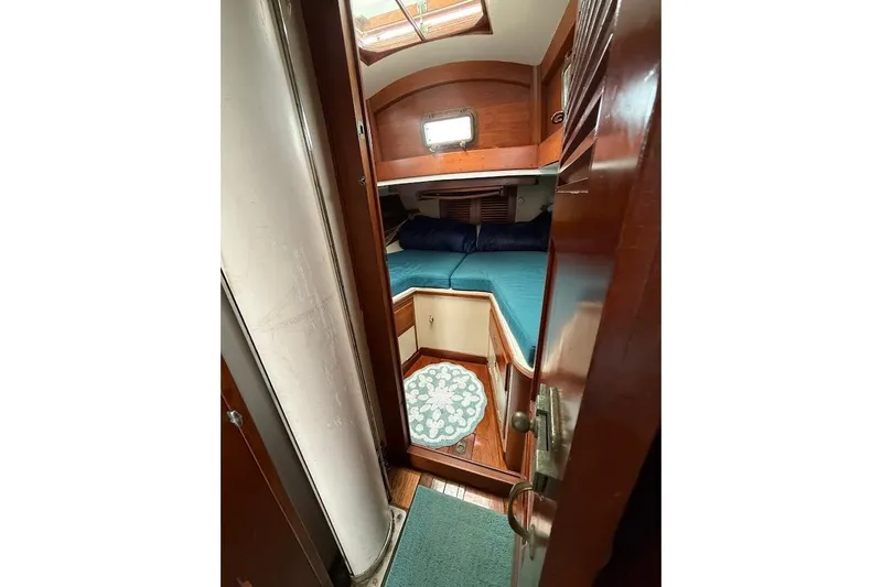 Slide: The Image of Interior cabin of 1962 Ted Hood Little Harbor 40 Yawl, featuring cozy bedding and wooden finishes. - 16
