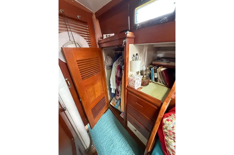 Slide: The Image of Interior of 1962 Ted Hood Little Harbor 40 Yawl, featuring wooden cabinetry and cozy storage. - 17