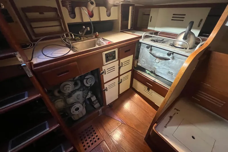 Slide: The Image of Interior of 1962 Ted Hood Little Harbor 40 Yawl, featuring a compact kitchen area. - 18