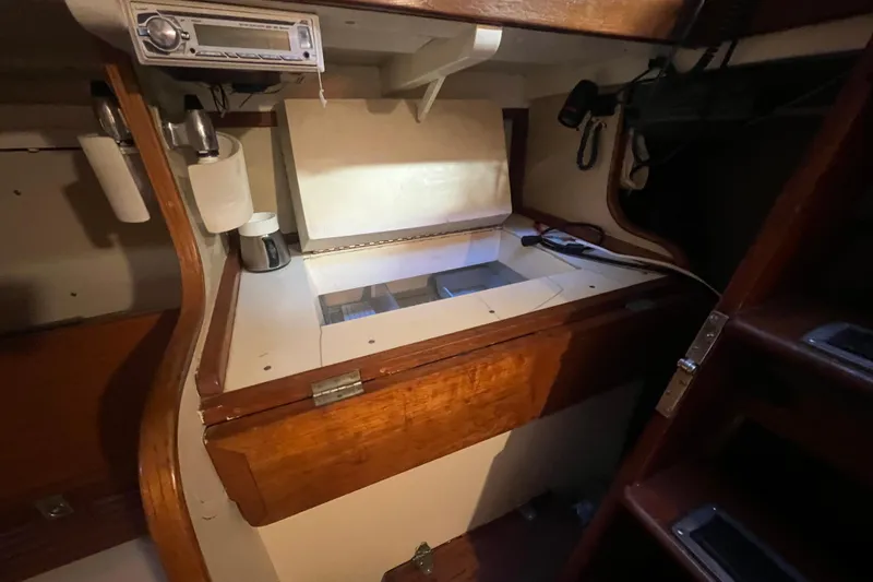 Slide: The Image of Interior of 1962 Ted Hood Little Harbor 40 Yawl, featuring wooden cabinetry and storage. - 19