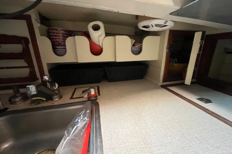 Slide: The Image of Interior of 1962 Ted Hood Little Harbor 40 Yawl, featuring kitchen storage and sink area. - 20
